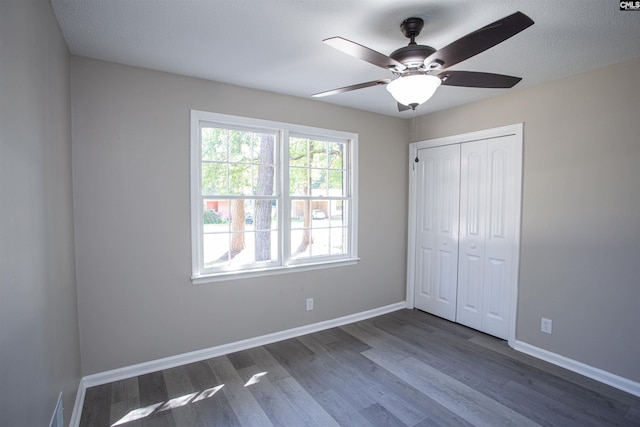 4513 Bonnie Forest Blvd, Columbia, SC 29210 - unfurnished bedroom featuring dark wood finished floors, a closet, baseboards, and ceiling fan