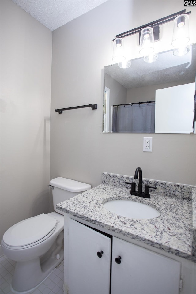 4513 Bonnie Forest Blvd, Columbia, SC 29210 - bathroom with vanity, toilet, tile patterned floors, and a textured ceiling