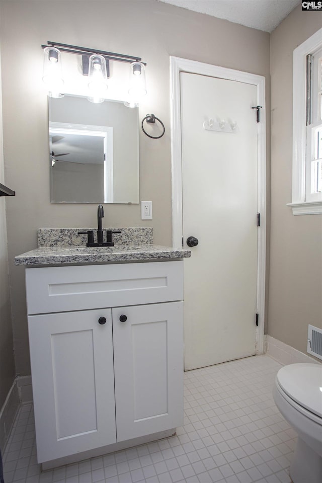 4513 Bonnie Forest Blvd, Columbia, SC 29210 - bathroom with vanity, toilet, a ceiling fan, and tile patterned flooring