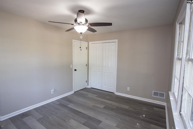4513 Bonnie Forest Blvd, Columbia, SC 29210 - unfurnished bedroom with baseboards, dark wood-style floors, ceiling fan, and a closet