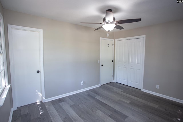 4513 Bonnie Forest Blvd, Columbia, SC 29210 - unfurnished bedroom featuring wood finished floors, baseboards, a ceiling fan, and a closet