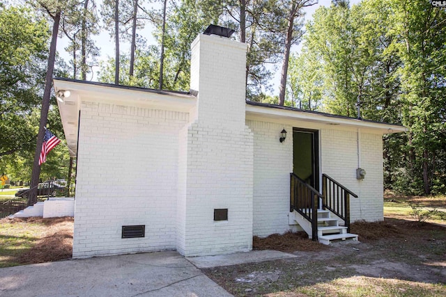 4513 Bonnie Forest Blvd, Columbia, SC 29210 - view of side of home featuring entry steps, a chimney, crawl space, and brick siding