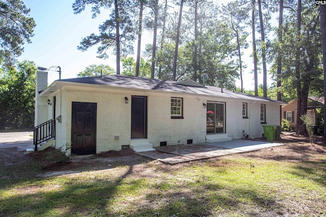 4513 Bonnie Forest Blvd, Columbia, SC 29210 - back of property featuring entry steps, a chimney, a lawn, a patio, and brick siding