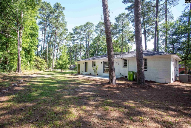 4513 Bonnie Forest Blvd, Columbia, SC 29210 - rear view of house featuring brick siding and a patio area