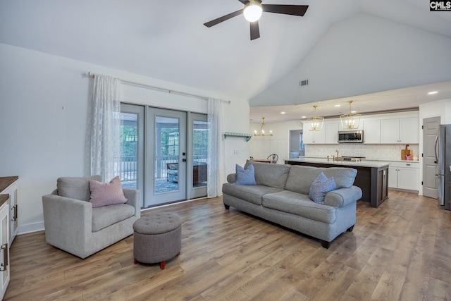 67 Ole Still Ln, Elgin, SC 29045 - living room featuring ceiling fan, a chandelier, light wood-type flooring, high vaulted ceiling, and recessed lighting
