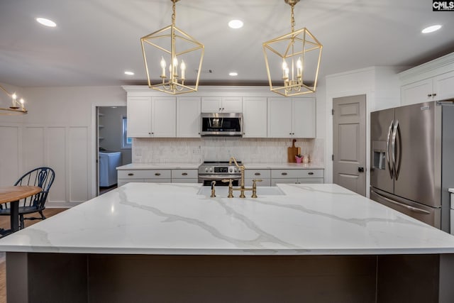 67 Ole Still Ln, Elgin, SC 29045 - kitchen featuring appliances with stainless steel finishes, a chandelier, a spacious island, backsplash, and recessed lighting