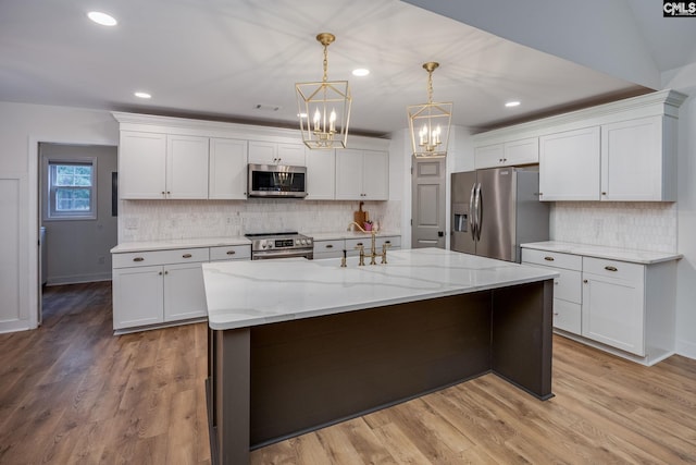 67 Ole Still Ln, Elgin, SC 29045 - kitchen with stainless steel appliances, a chandelier, white cabinets, and recessed lighting