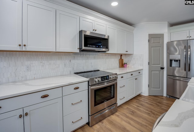 67 Ole Still Ln, Elgin, SC 29045 - kitchen with stainless steel appliances, light wood finished floors, decorative backsplash, and light stone counters
