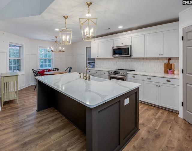 67 Ole Still Ln, Elgin, SC 29045 - kitchen with appliances with stainless steel finishes, a sink, a chandelier, and white cabinetry