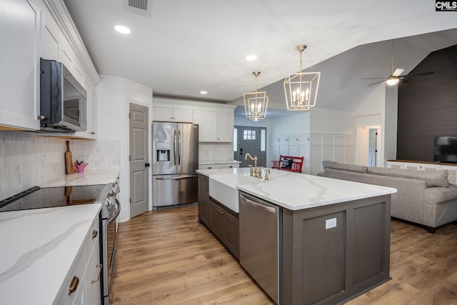 67 Ole Still Ln, Elgin, SC 29045 - kitchen featuring stainless steel appliances, tasteful backsplash, a ceiling fan, a chandelier, and a sink