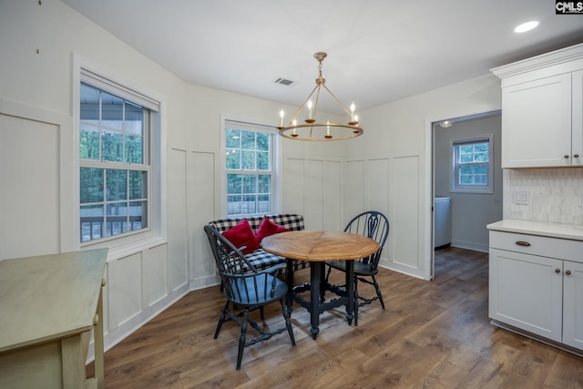 67 Ole Still Ln, Elgin, SC 29045 - dining room with a chandelier, dark wood-style flooring, plenty of natural light, and a decorative wall