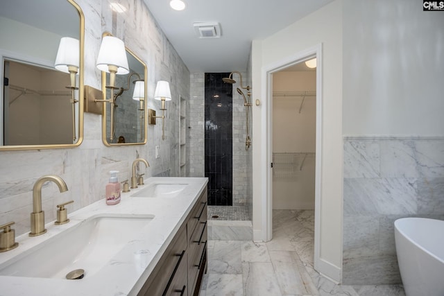 67 Ole Still Ln, Elgin, SC 29045 - full bathroom with tile walls, a stall shower, double vanity, marble look tiles, and a walk in closet