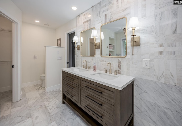 67 Ole Still Ln, Elgin, SC 29045 - bathroom featuring double vanity, toilet, baseboards, a walk in closet, and recessed lighting