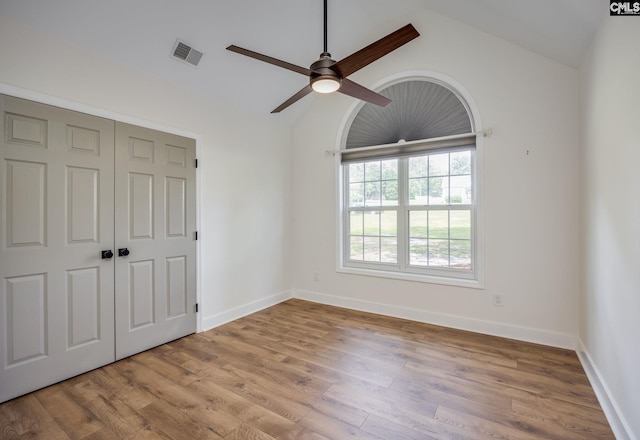 67 Ole Still Ln, Elgin, SC 29045 - unfurnished bedroom with lofted ceiling, wood finished floors, a closet, baseboards, and a ceiling fan