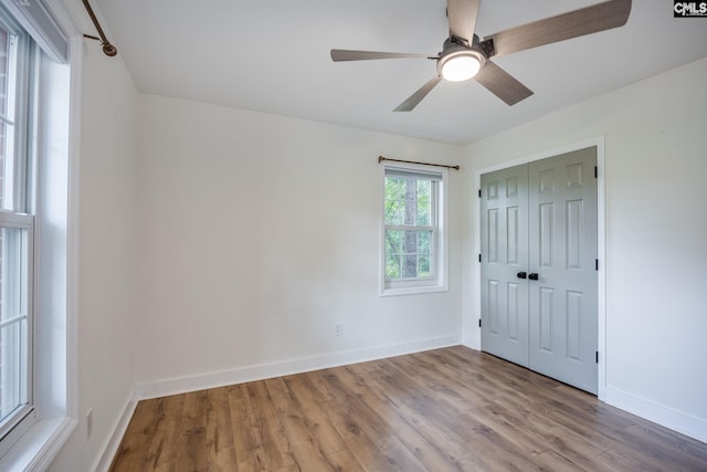 67 Ole Still Ln, Elgin, SC 29045 - unfurnished bedroom featuring wood finished floors, baseboards, a closet, and a ceiling fan