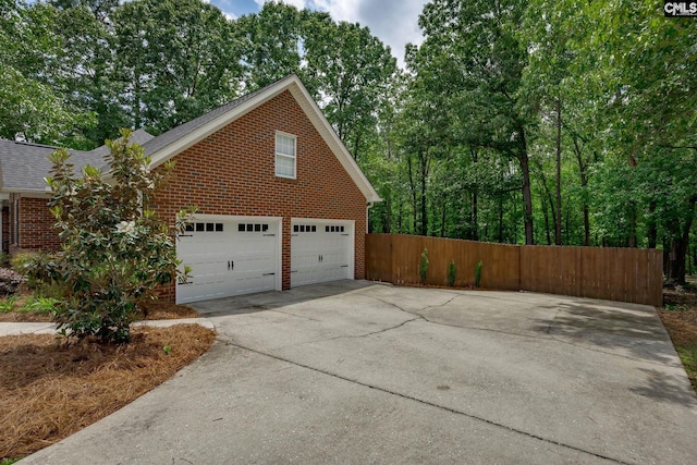 67 Ole Still Ln, Elgin, SC 29045 - view of home's exterior featuring brick siding, a garage, concrete driveway, and a shingled roof