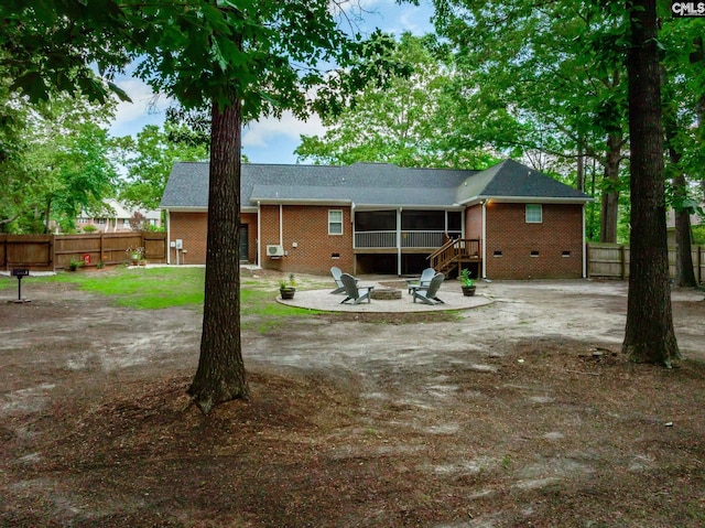 67 Ole Still Ln, Elgin, SC 29045 - back of property with an outdoor fire pit, brick siding, a sunroom, and a patio area