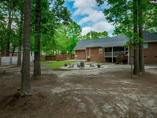 67 Ole Still Ln, Elgin, SC 29045 - view of yard featuring stairway, a fire pit, a patio, and a sunroom