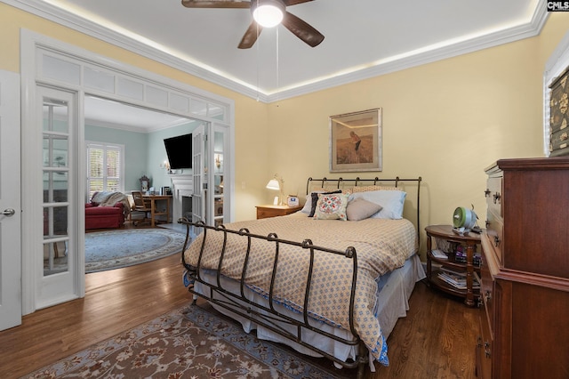 6148 Marthas Glen Rd, Columbia, SC 29209 - bedroom featuring ornamental molding, wood finished floors, a fireplace, a ceiling fan, and a tray ceiling
