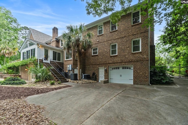 6148 Marthas Glen Rd, Columbia, SC 29209 - rear view of property with a garage, brick siding, concrete driveway, and cooling unit