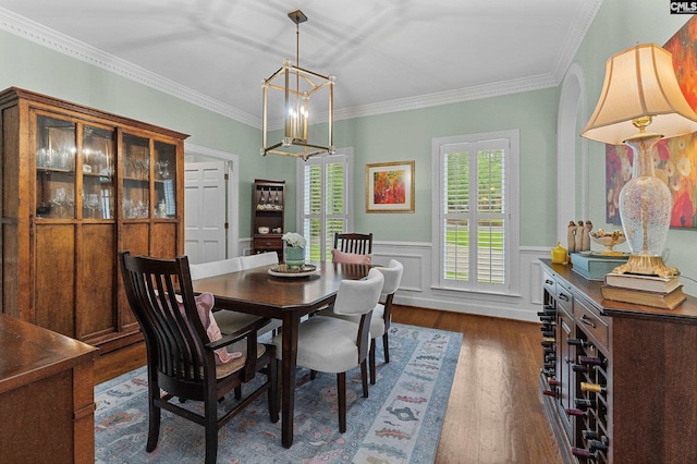 6148 Marthas Glen Rd, Columbia, SC 29209 - dining room featuring dark wood-type flooring, a chandelier, crown molding, and a wainscoted wall
