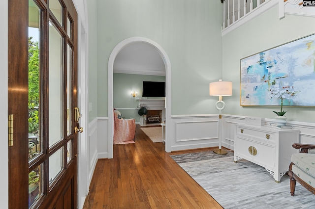 6148 Marthas Glen Rd, Columbia, SC 29209 - foyer with healthy amount of natural light, wood finished floors, arched walkways, a wainscoted wall, and a decorative wall