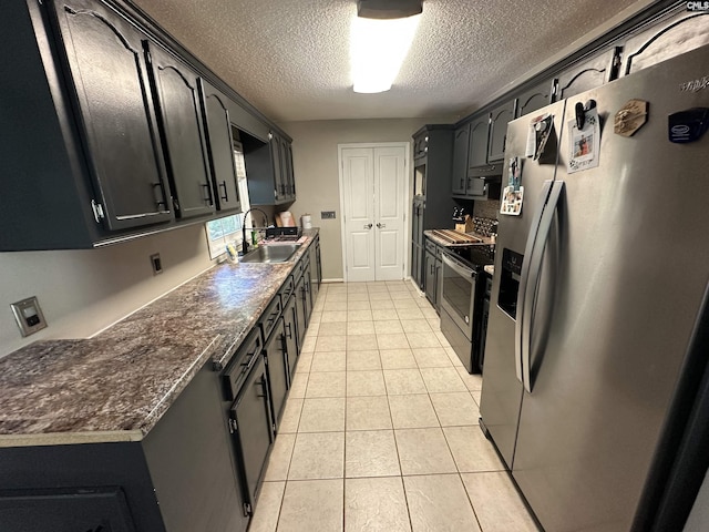 109 Cranewater Dr, Columbia, SC 29212 - kitchen featuring appliances with stainless steel finishes, a sink, light tile patterned floors, a textured ceiling, and dark countertops