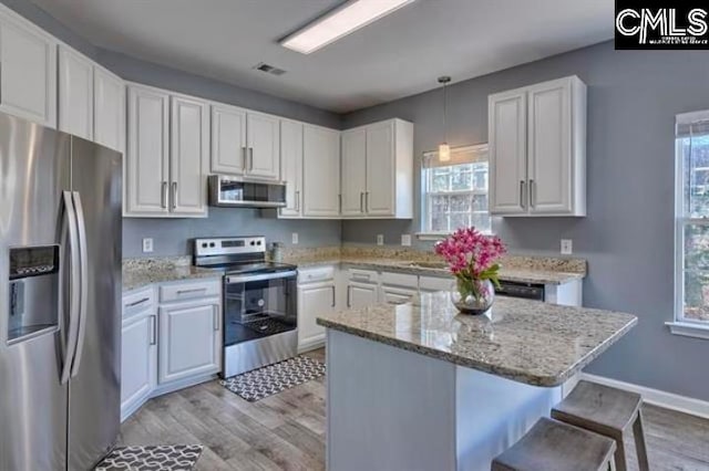 2 Alverston Ct, Irmo, SC 29063 - kitchen featuring stainless steel appliances, light wood-type flooring, and white cabinetry