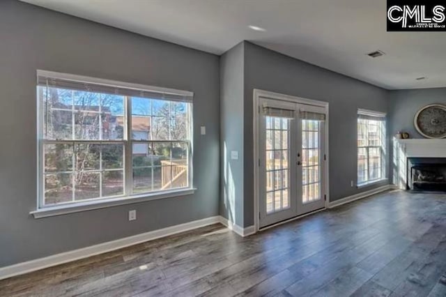 2 Alverston Ct, Irmo, SC 29063 - unfurnished living room with wood finished floors, french doors, baseboards, and a fireplace with flush hearth