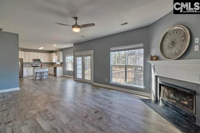 2 Alverston Ct, Irmo, SC 29063 - unfurnished living room with ceiling fan, wood finished floors, a fireplace, and baseboards