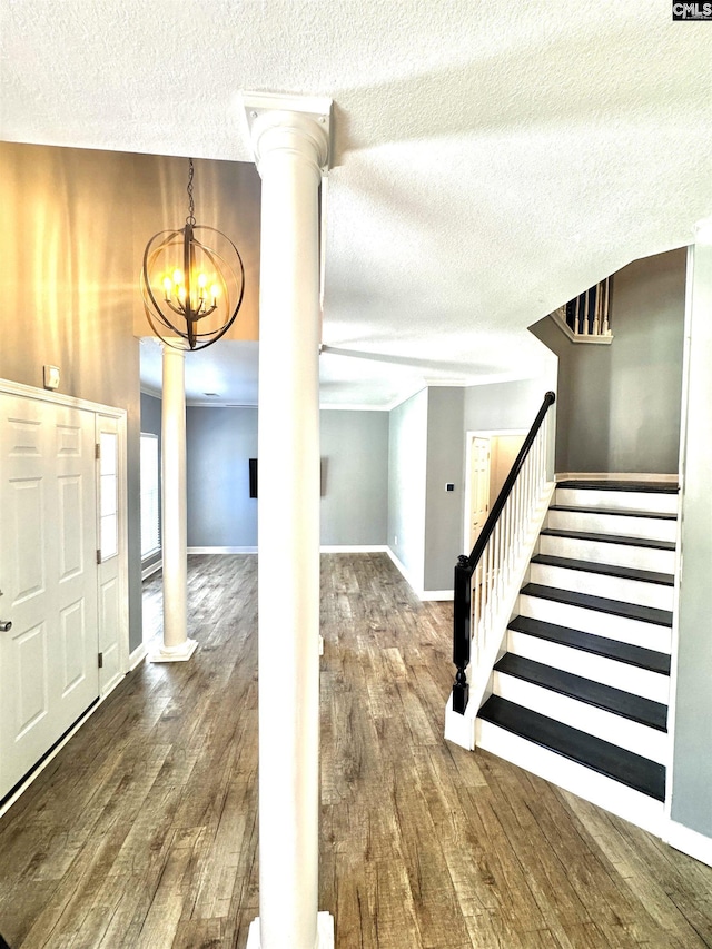 2 Alverston Ct, Irmo, SC 29063 - foyer with decorative columns, wood finished floors, a textured ceiling, stairs, and a chandelier
