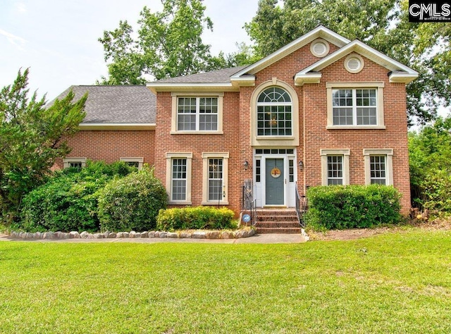 115 Chestnut Woods Ln, Columbia, SC 29212 - colonial inspired home featuring a front lawn, brick siding, and roof with shingles