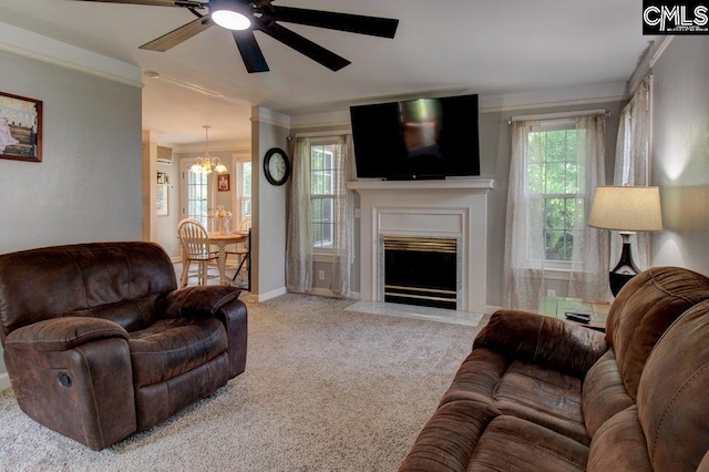 115 Chestnut Woods Ln, Columbia, SC 29212 - carpeted living room with ceiling fan, a chandelier, a fireplace with flush hearth, baseboards, and ornamental molding