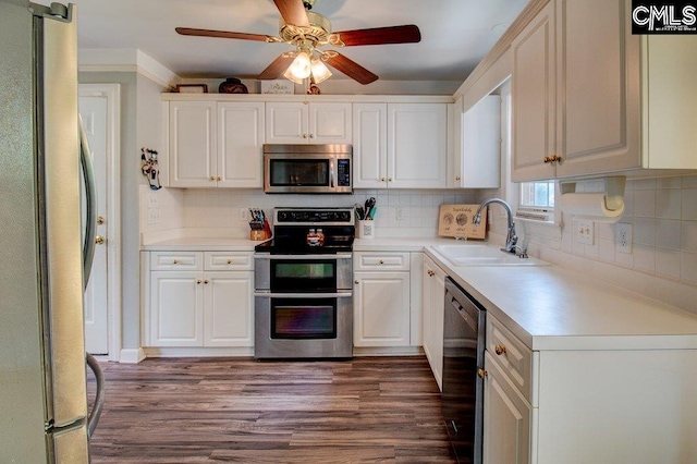 115 Chestnut Woods Ln, Columbia, SC 29212 - kitchen with appliances with stainless steel finishes, a sink, ceiling fan, white cabinetry, and dark wood finished floors