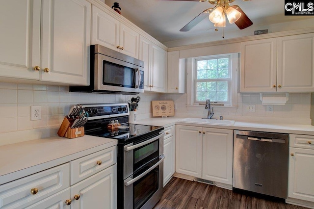 115 Chestnut Woods Ln, Columbia, SC 29212 - kitchen with stainless steel appliances, a sink, ceiling fan, tasteful backsplash, and white cabinets