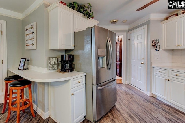 115 Chestnut Woods Ln, Columbia, SC 29212 - kitchen featuring stainless steel fridge, crown molding, white cabinetry, wood finished floors, and ceiling fan