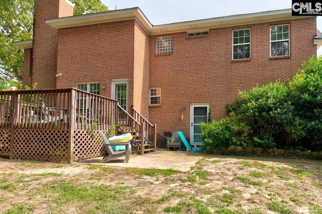 115 Chestnut Woods Ln, Columbia, SC 29212 - rear view of property with a chimney, brick siding, and a deck