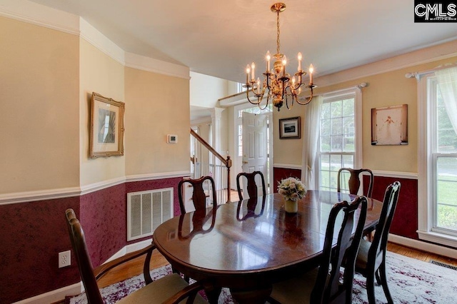 115 Chestnut Woods Ln, Columbia, SC 29212 - dining room with a chandelier, wainscoting, wood finished floors, and stairway