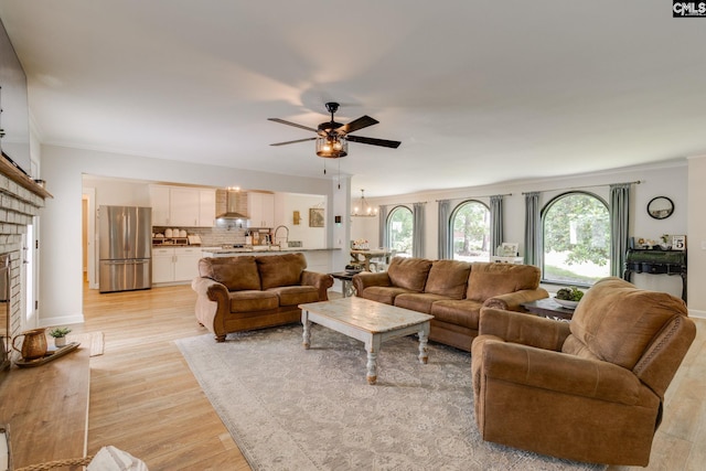216 Jacobs Mill Pond Rd, Elgin, SC 29045 - living area with ceiling fan, light wood-type flooring, ornamental molding, a brick fireplace, and a chandelier