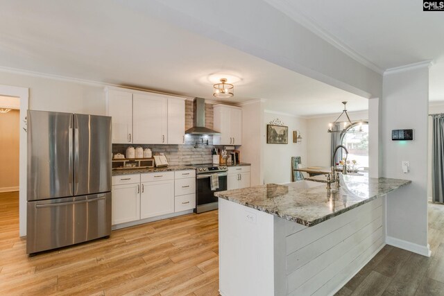 216 Jacobs Mill Pond Rd, Elgin, SC 29045 - kitchen with appliances with stainless steel finishes, wall chimney range hood, light wood-style floors, white cabinetry, and crown molding
