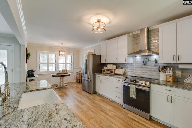 216 Jacobs Mill Pond Rd, Elgin, SC 29045 - kitchen featuring wall chimney range hood, appliances with stainless steel finishes, a chandelier, ornamental molding, and light wood-style floors
