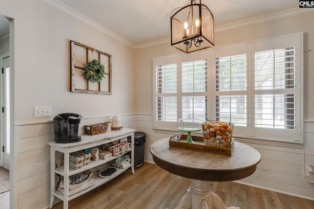 216 Jacobs Mill Pond Rd, Elgin, SC 29045 - dining space with a chandelier, wood finished floors, crown molding, and a wainscoted wall