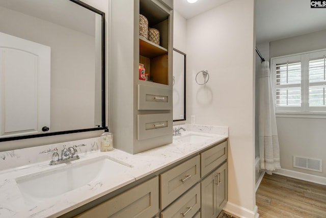 216 Jacobs Mill Pond Rd, Elgin, SC 29045 - full bath with double vanity, shower / bath combo with shower curtain, wood finished floors, and baseboards