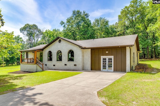 216 Jacobs Mill Pond Rd, Elgin, SC 29045 - view of front of house with french doors, board and batten siding, driveway, a front lawn, and brick siding