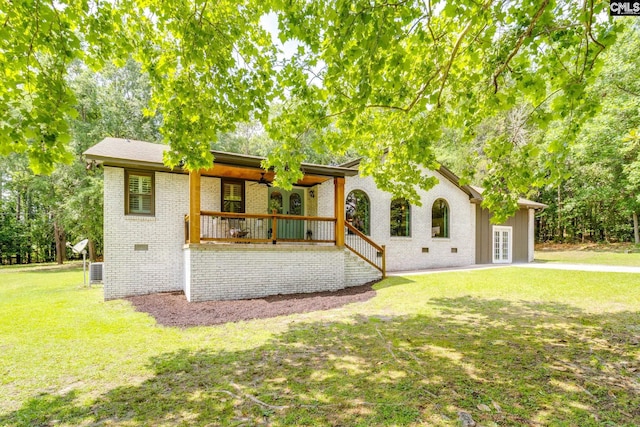 216 Jacobs Mill Pond Rd, Elgin, SC 29045 - view of front of home with brick siding, a front lawn, french doors, a porch, and central AC