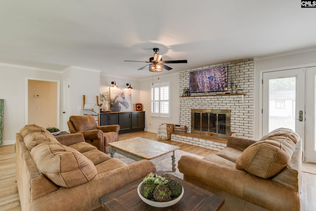 216 Jacobs Mill Pond Rd, Elgin, SC 29045 - living room featuring light wood-style floors, ornamental molding, ceiling fan, a brick fireplace, and baseboards