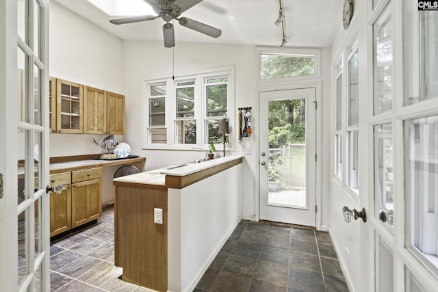 111 Rusty Barn Rd, Columbia, SC 29212 - kitchen featuring glass insert cabinets, a ceiling fan, lofted ceiling, brown cabinets, and a peninsula