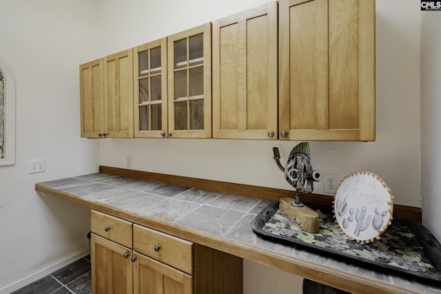 111 Rusty Barn Rd, Columbia, SC 29212 - kitchen featuring tile counters, glass insert cabinets, dark tile patterned floors, and baseboards