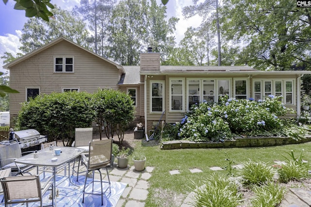 111 Rusty Barn Rd, Columbia, SC 29212 - back of property with a chimney, outdoor dining space, a yard, and a patio