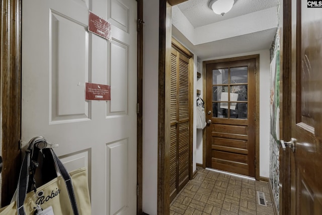111 Rusty Barn Rd, Columbia, SC 29212 - doorway with brick patterned flooring, baseboards, and a textured ceiling